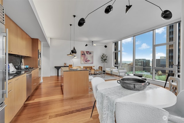 dining area featuring floor to ceiling windows and light hardwood / wood-style flooring