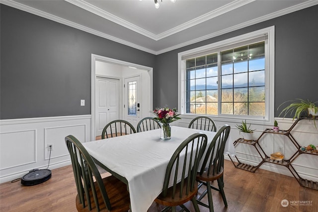 dining area featuring dark hardwood / wood-style floors and crown molding