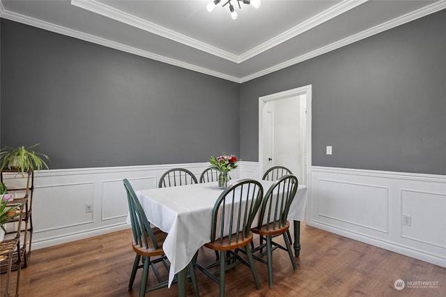 dining room featuring dark hardwood / wood-style floors and crown molding