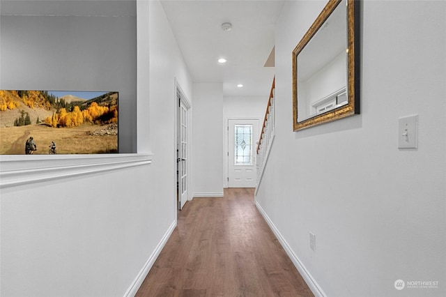 hallway with hardwood / wood-style floors