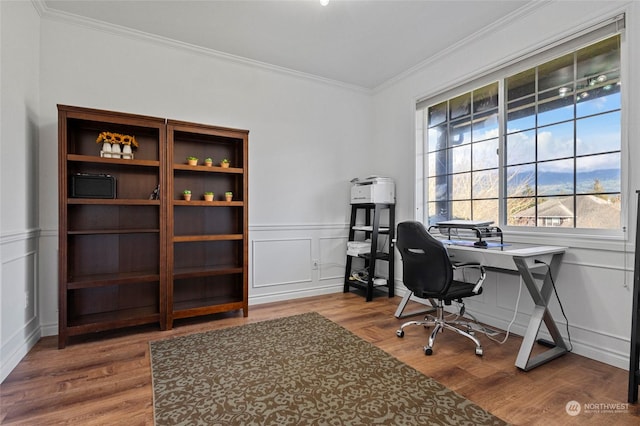 home office featuring hardwood / wood-style flooring and ornamental molding