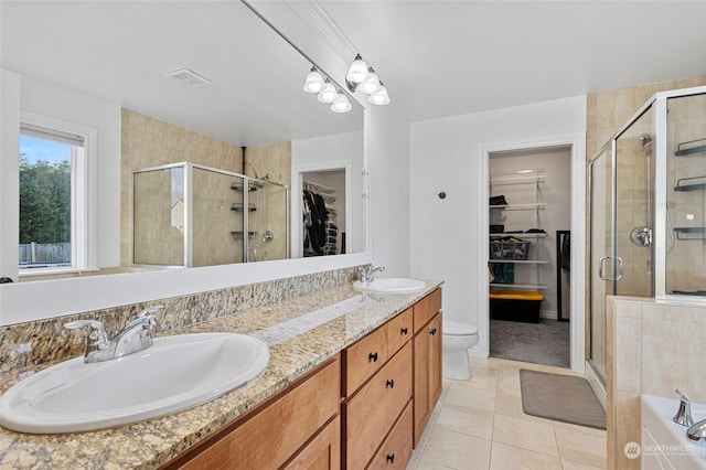 bathroom with walk in shower, vanity, tile patterned flooring, and toilet