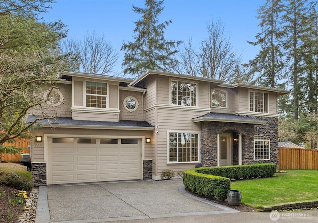 view of front of home with a front yard, fence, concrete driveway, a garage, and stone siding