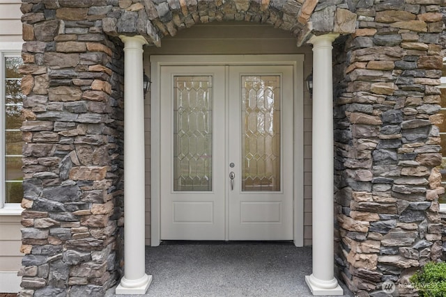 property entrance featuring stone siding