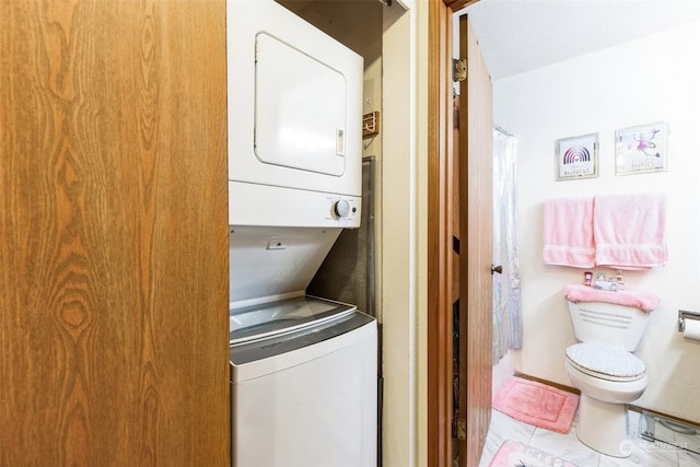 washroom with stacked washer / drying machine