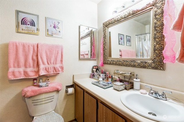 bathroom featuring walk in shower and vanity