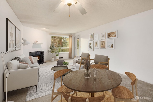 living room featuring a fireplace, ceiling fan, and carpet flooring