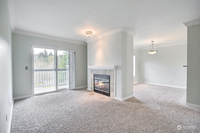 unfurnished living room with a tile fireplace, ornamental molding, and carpet flooring