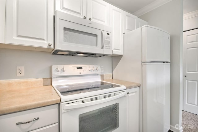 kitchen with ornamental molding, white cabinets, and white appliances