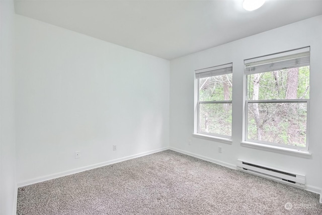 carpeted empty room with a baseboard radiator