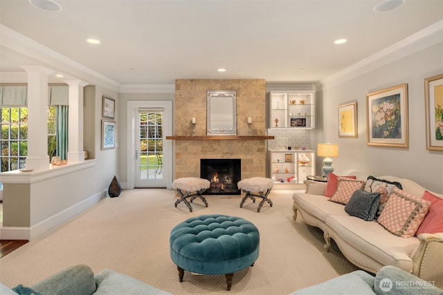 carpeted living room with recessed lighting, baseboards, a large fireplace, and ornamental molding