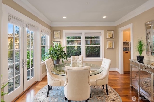 dining space with wood finished floors, recessed lighting, french doors, and baseboards