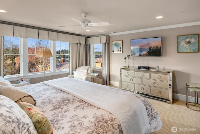 bedroom featuring a ceiling fan, baseboards, recessed lighting, ornamental molding, and light carpet