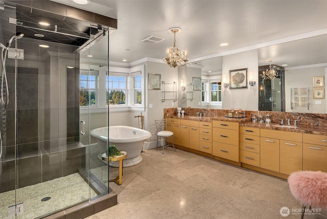 bathroom with visible vents, a shower stall, an inviting chandelier, and double vanity