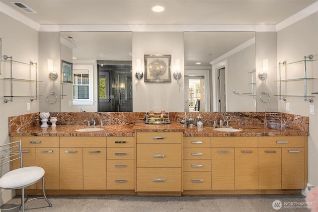 bathroom with double vanity, visible vents, crown molding, and a sink