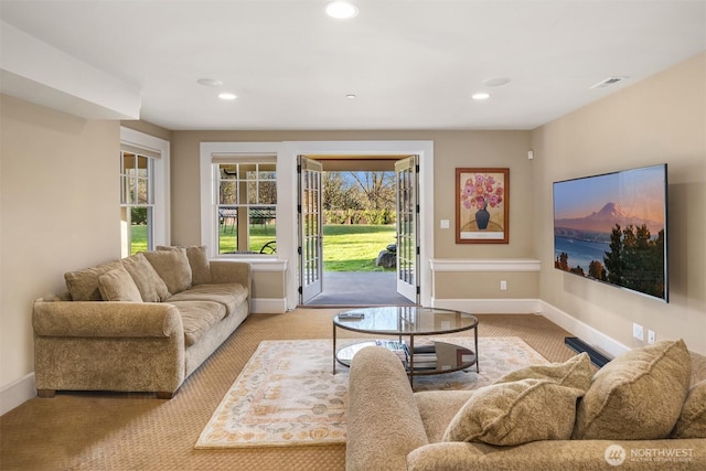 living room featuring recessed lighting, baseboards, and visible vents