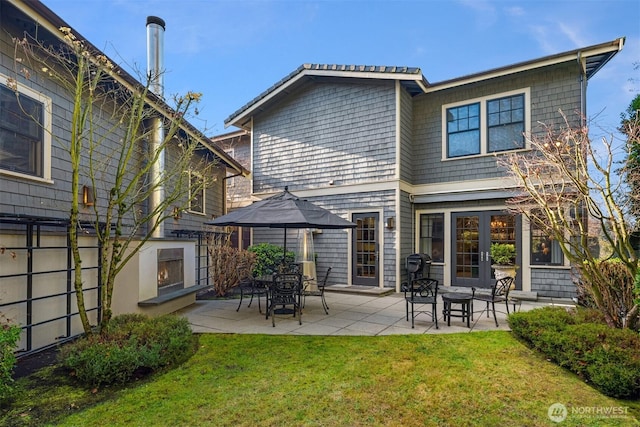 back of house with a yard and a patio area