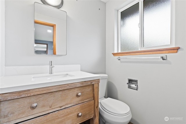 bathroom with toilet and vanity