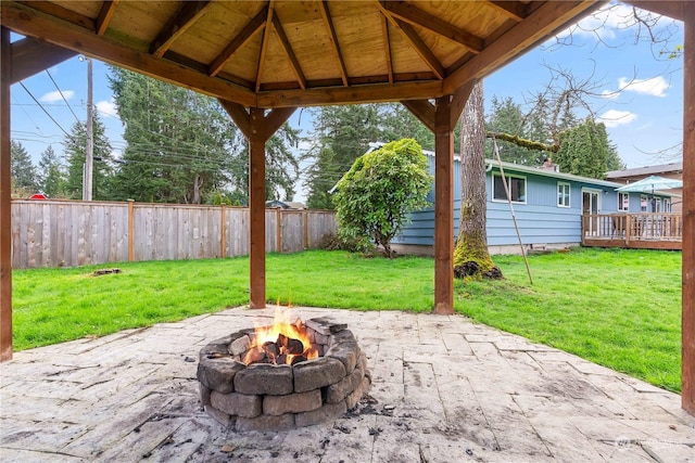 view of patio / terrace with a wooden deck, a gazebo, and a fire pit