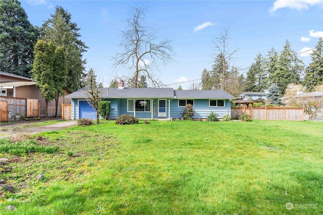 ranch-style house with a garage and a front yard