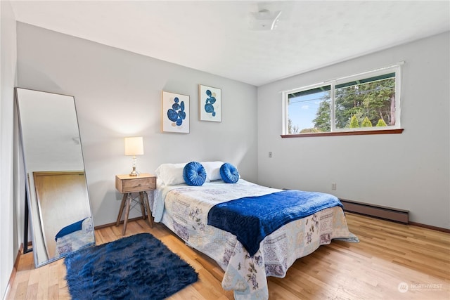 bedroom featuring a baseboard radiator and light wood-type flooring