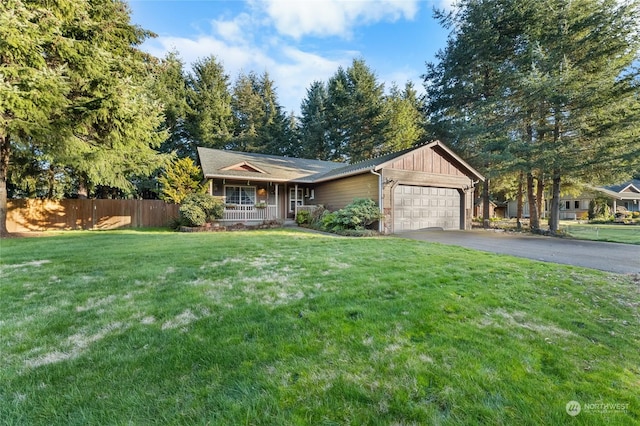 ranch-style home with a garage, covered porch, and a front lawn