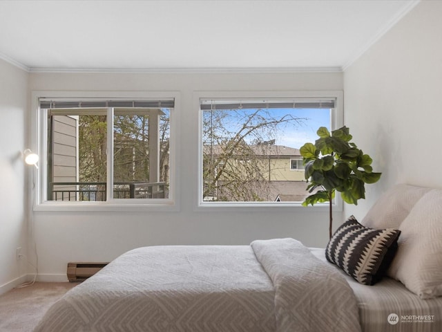 bedroom with a baseboard heating unit, carpet, and crown molding