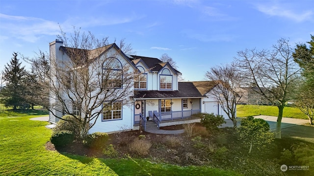 view of front of property with a front lawn, a porch, and a garage