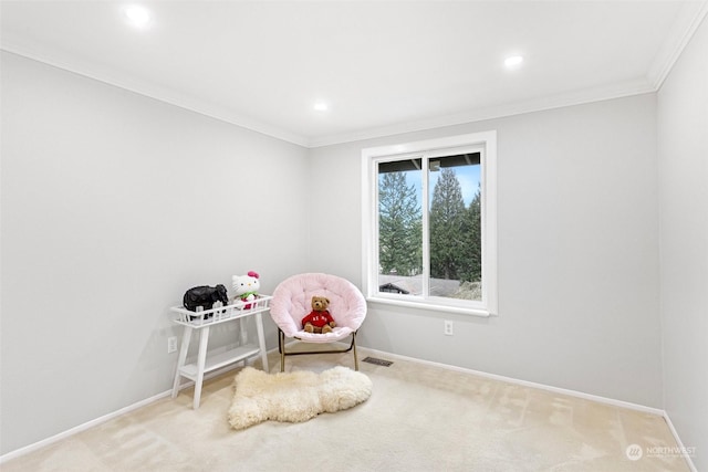 sitting room with crown molding and carpet