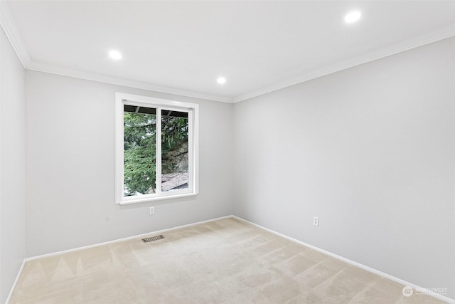 empty room with ornamental molding and light carpet