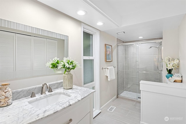 bathroom with vanity, tile patterned flooring, and walk in shower