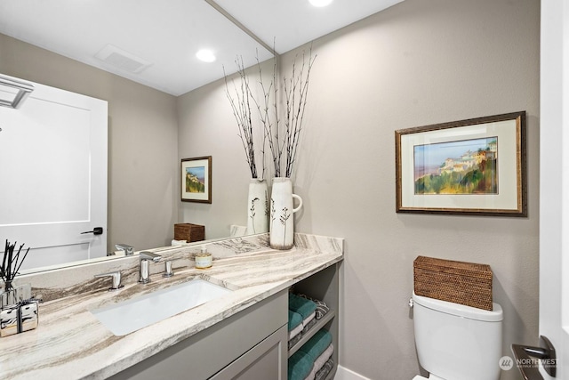 bathroom featuring vanity and toilet