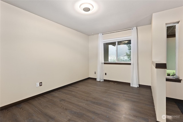 unfurnished room with dark hardwood / wood-style floors