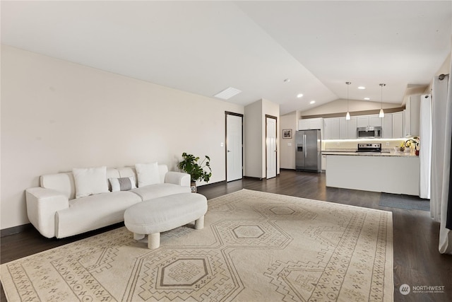 living room with dark wood-type flooring and vaulted ceiling