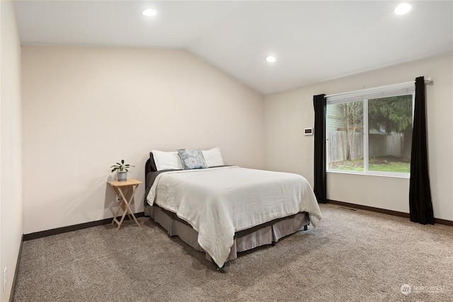 bedroom featuring lofted ceiling and carpet flooring