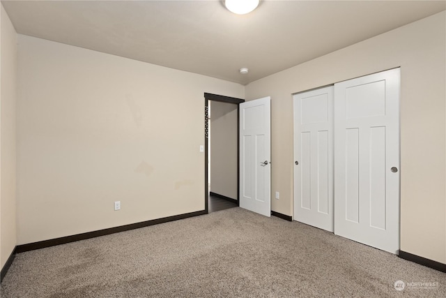 unfurnished bedroom featuring a closet and carpet floors