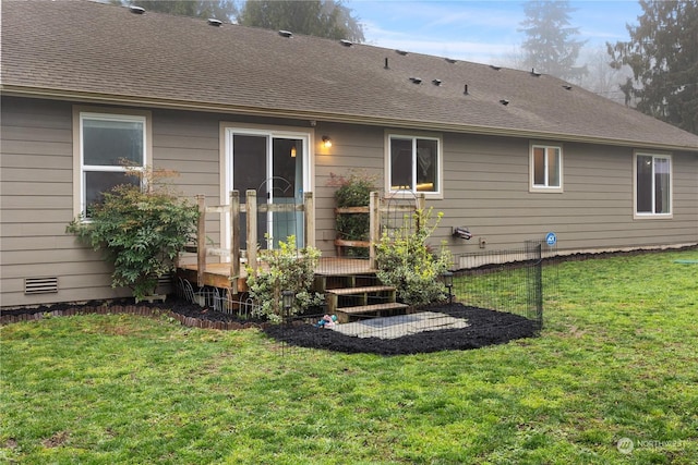 rear view of house featuring a lawn