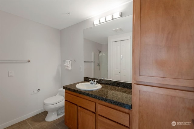 bathroom with toilet, tile patterned floors, walk in shower, and vanity