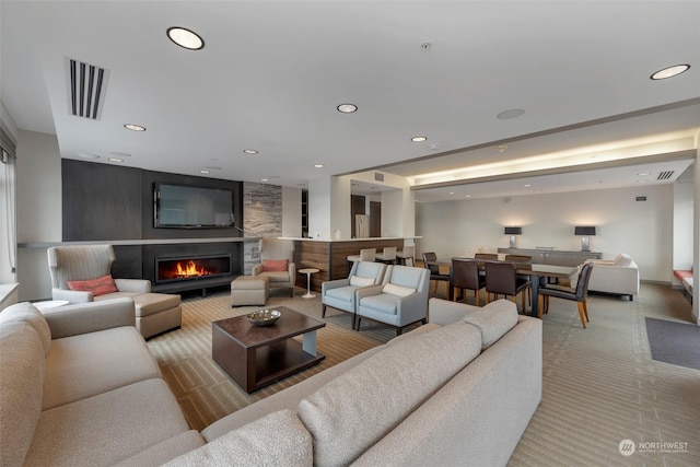 carpeted living room featuring a fireplace