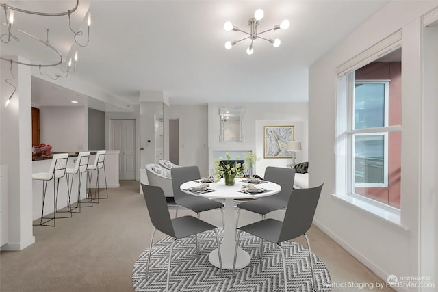 carpeted dining area featuring an inviting chandelier