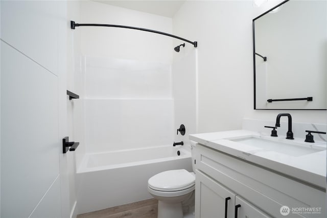 bathroom with toilet, bathtub / shower combination, vanity, and wood finished floors