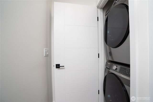 washroom featuring stacked washer / dryer