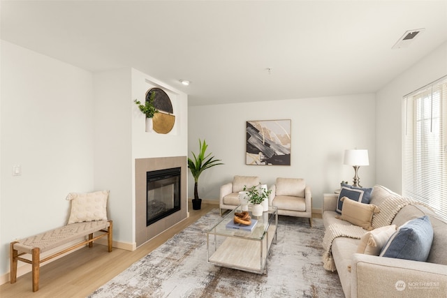 living room with hardwood / wood-style flooring and a fireplace