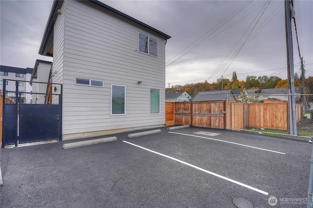 uncovered parking lot featuring fence