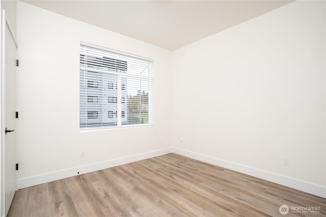 empty room featuring light wood-style floors and baseboards