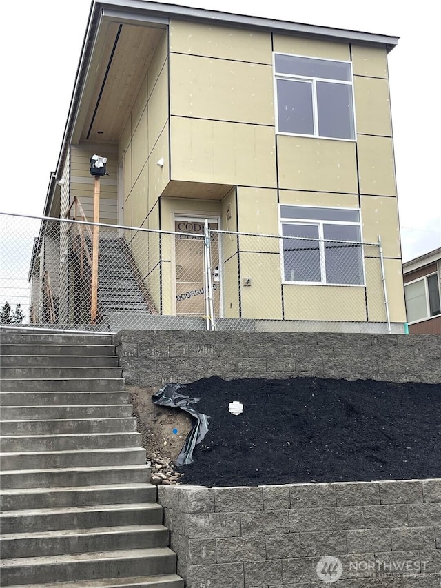 exterior space featuring stairs and fence