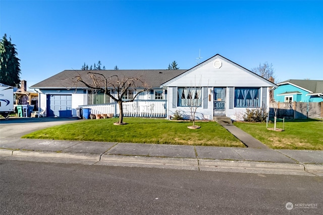 ranch-style house featuring a garage and a front lawn