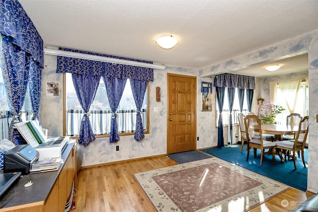 entrance foyer featuring a textured ceiling and light hardwood / wood-style floors