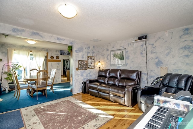 living room featuring hardwood / wood-style flooring and a textured ceiling