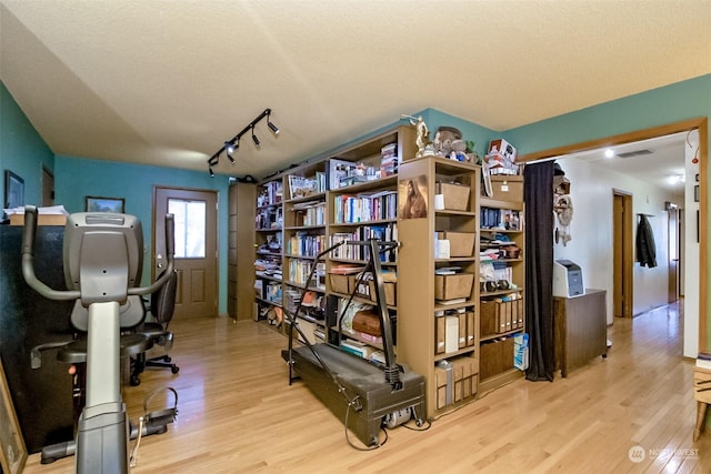 office area featuring track lighting, a textured ceiling, and light wood-type flooring